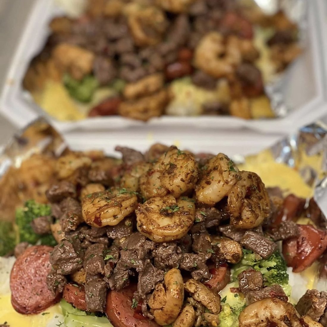 Shrimp, sausage and steak over the plate